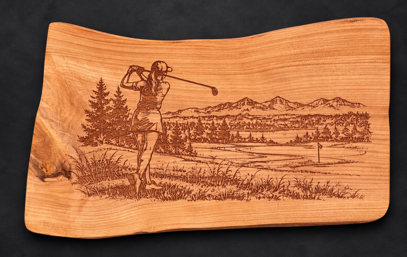 Completely bespoke wild-cherry golf board engraved with a woman golfer in the customer’s chosen landscape