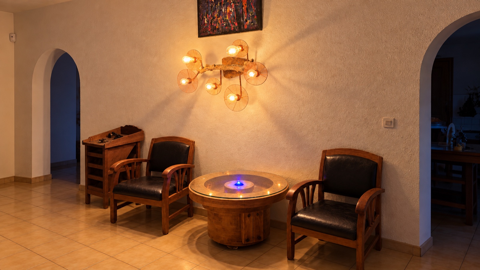 References LMR 2c and LMR 3d — crocheted-copper and driftwood wall lamp above the illuminated casting-mould table in Carol’s real living room