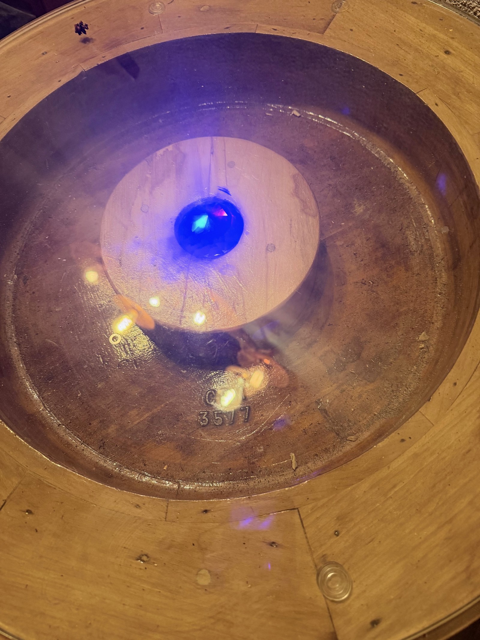 Reference LMR 3c — close view through the glass of the patinated interior of the 1920s casting mould and its central blue light